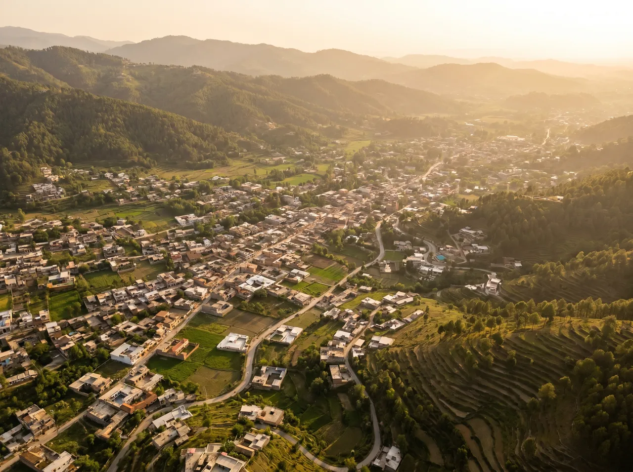 MacBook repair Abbottabad · aerial view of Abbottabad in the green Hazara hills · insured mail-in service to AppleForce Lahore